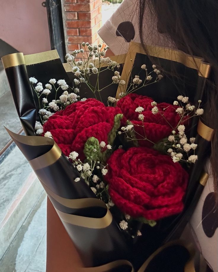 Handmade red crochet rose bouquet wrapped in black paper by Verity