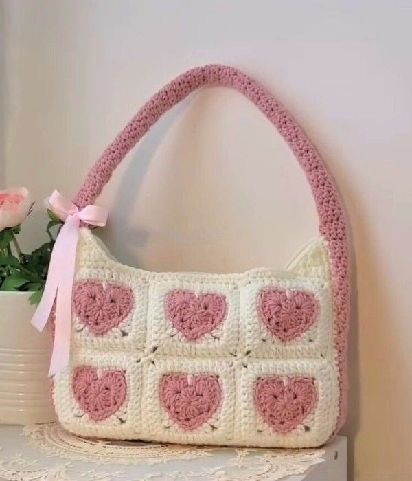 Handmade crochet heart shoulder bag in cream and pink with ribbon bow by Verity