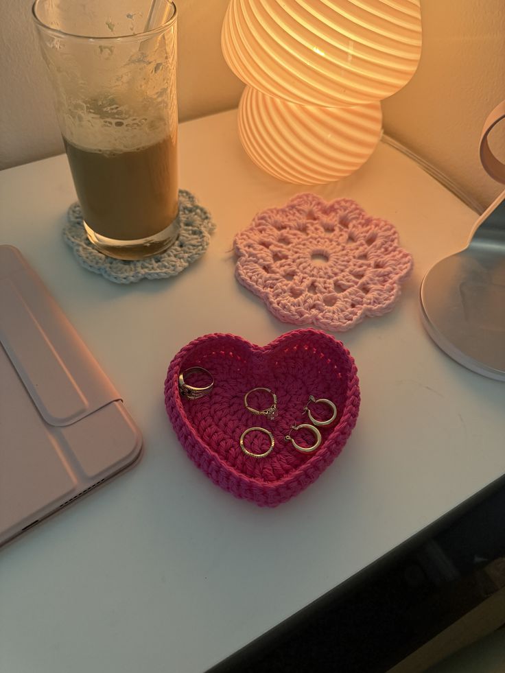 Handmade crochet heart trinket tray holding rings and jewelry