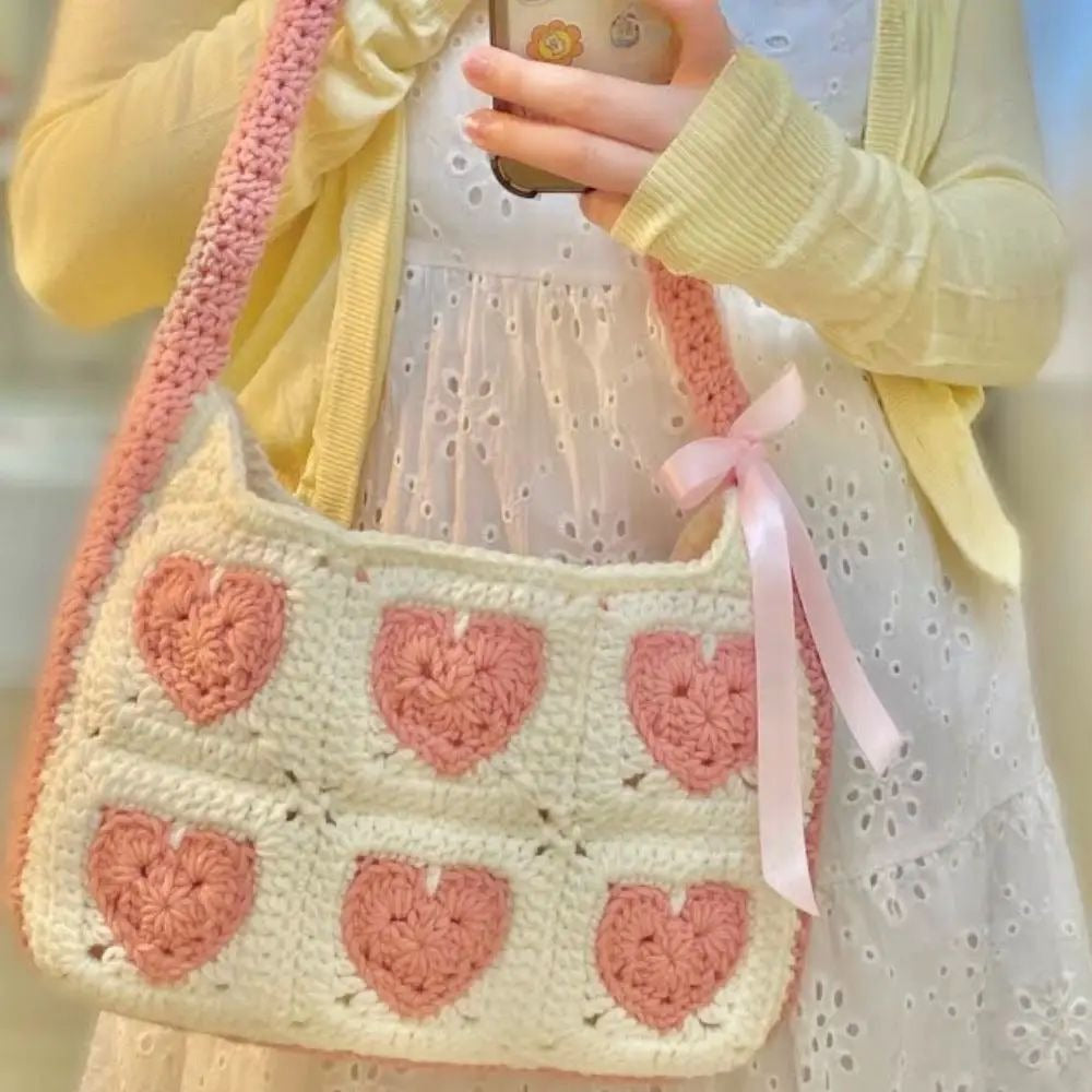 Handmade crochet heart shoulder bag in cream and pink with ribbon bow by Verity