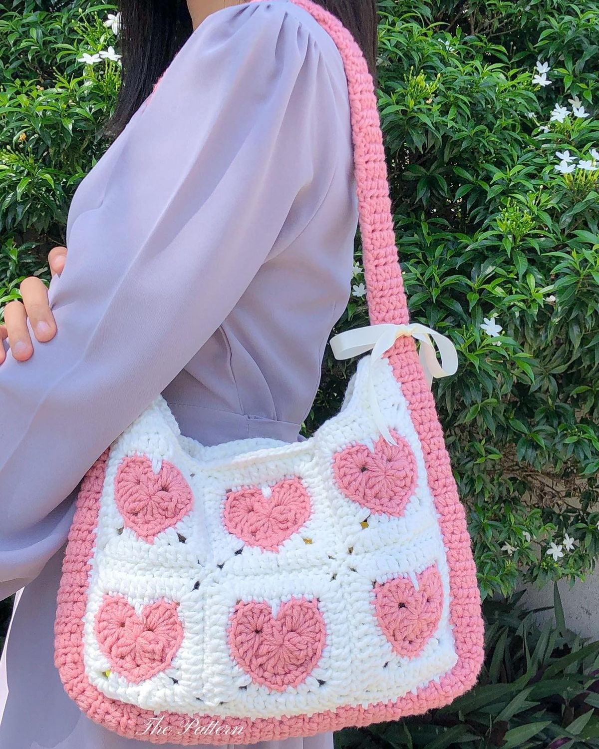 Handmade crochet heart shoulder bag in cream and pink with ribbon bow by Verity