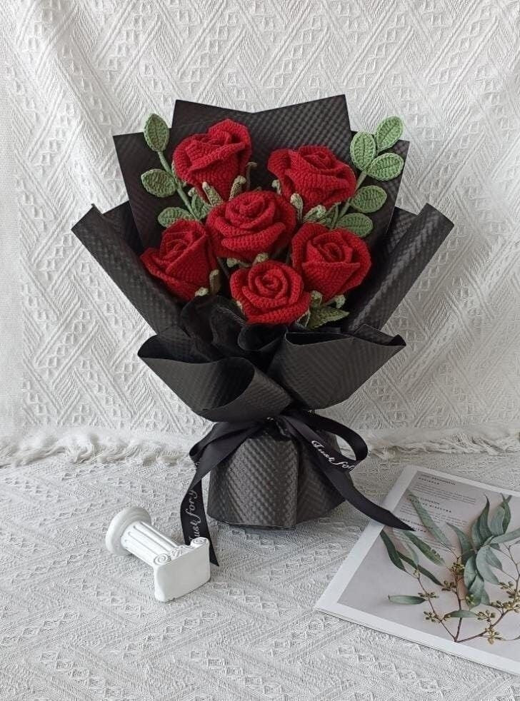 Handmade red crochet rose bouquet wrapped in black paper by Verity