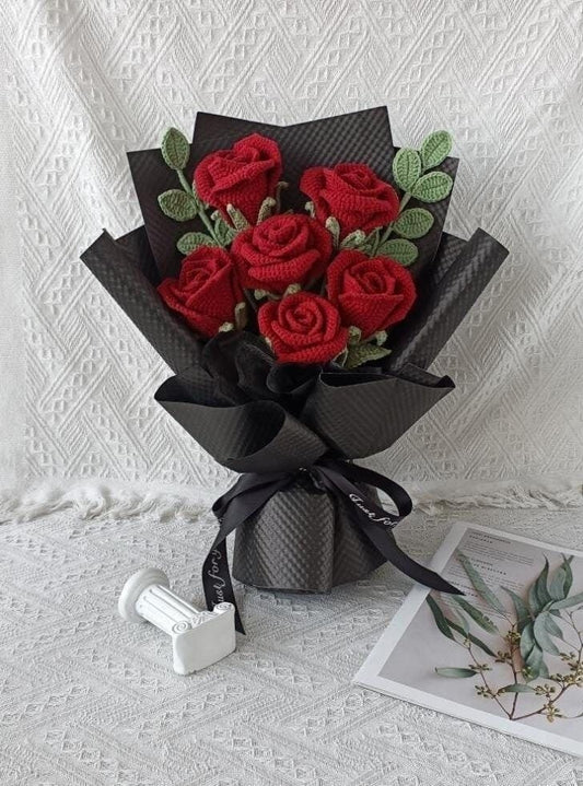 Handmade red crochet rose bouquet wrapped in black paper by Verity