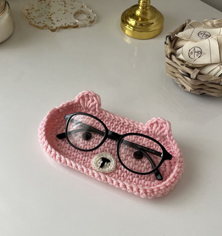 Handmade crochet bear glasses holder tray with eyeglasses.
