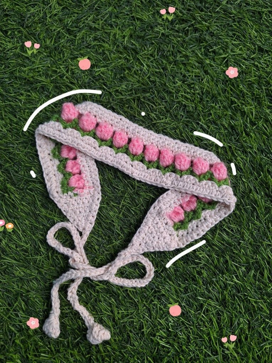 Handmade crochet floral headband with pink flowers on soft beige base